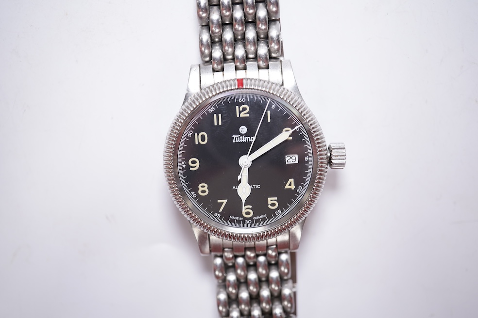 A gentleman's German stainless steel Tutima Flieger Automatic wrist watch, with black Arabic luminous dial and date aperture, cased diameter 36mm, on a stainless steel Tutima bracelet, with box and pamphlet. Condition -